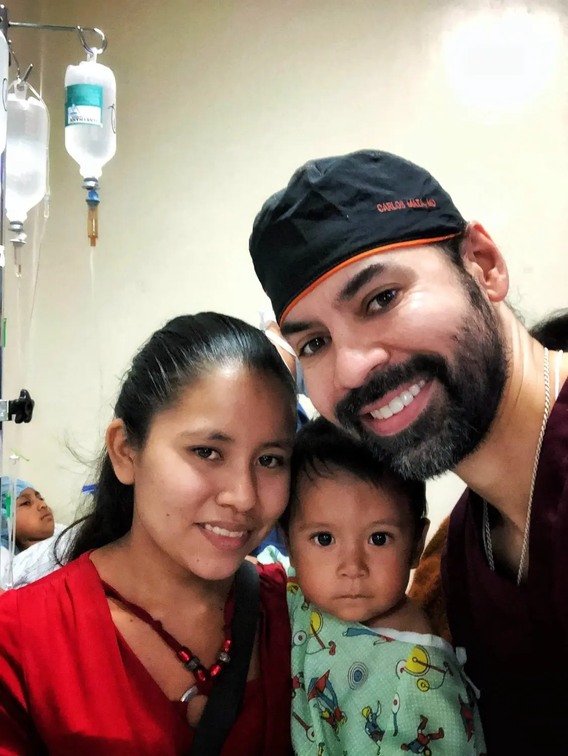 Dr. Mata with a mother and her infant in a recovery ward