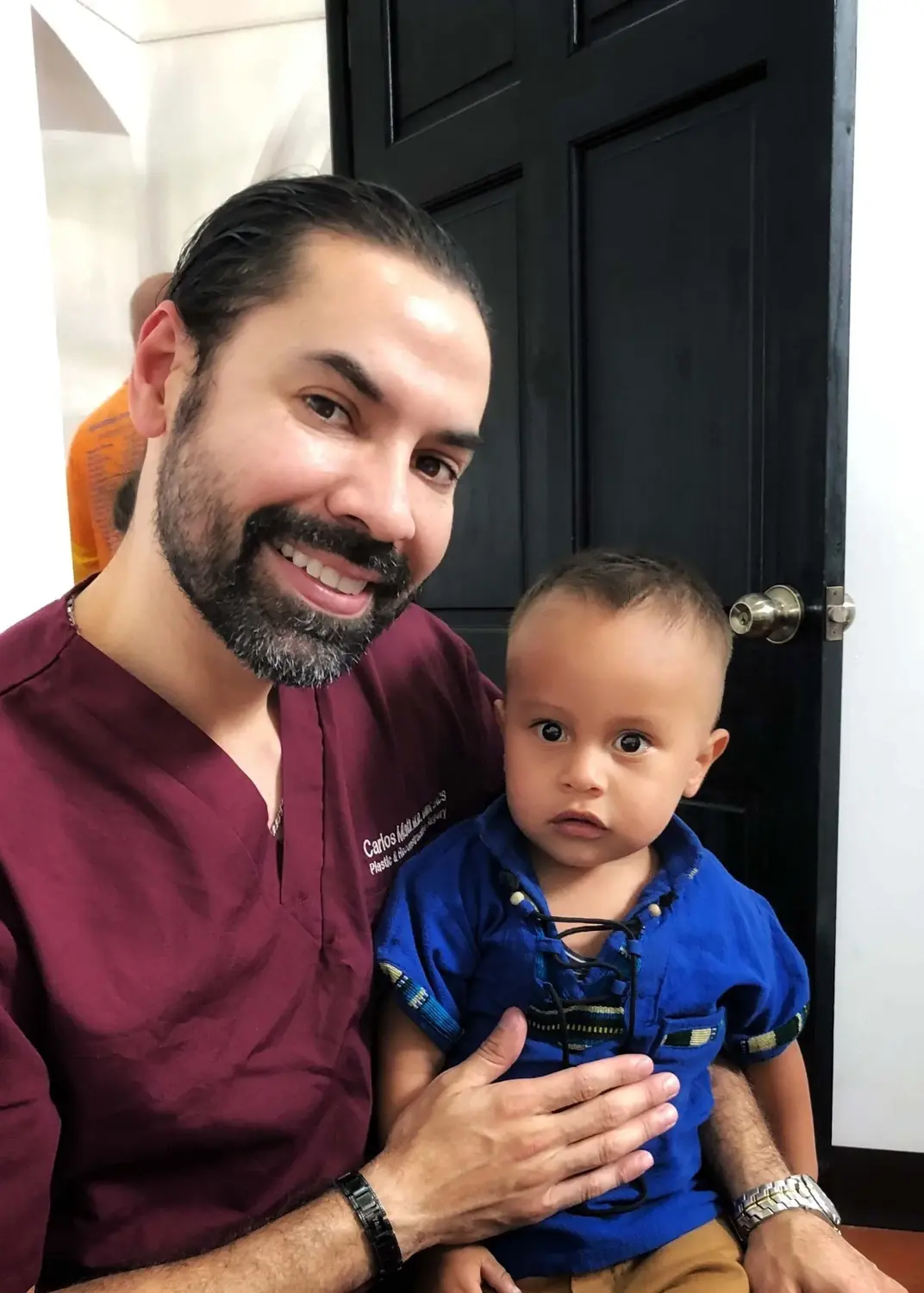 Dr. Mata and a young patient in pre-operative gowns