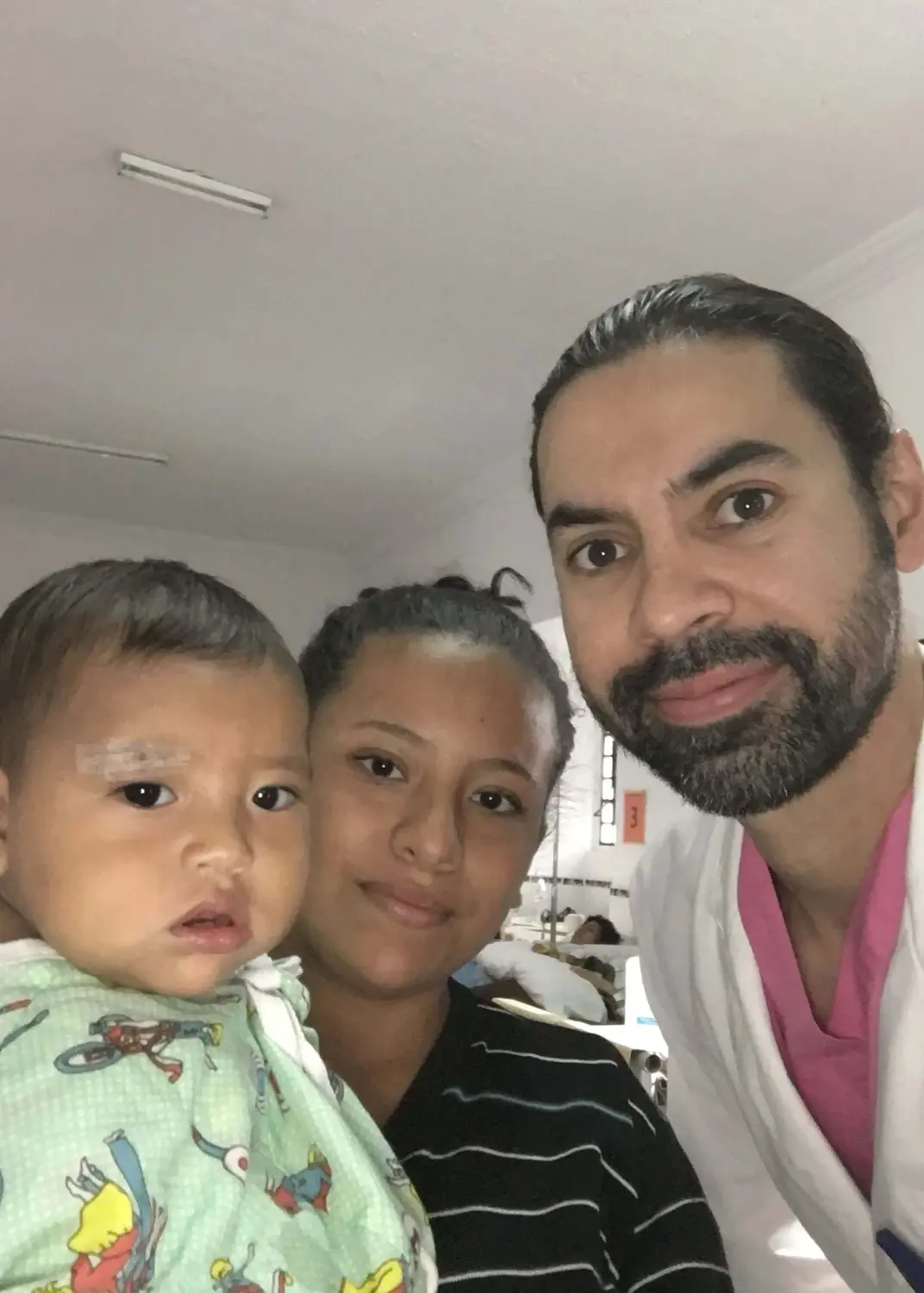 Dr. Mata with a mother and her infant in a recovery bay