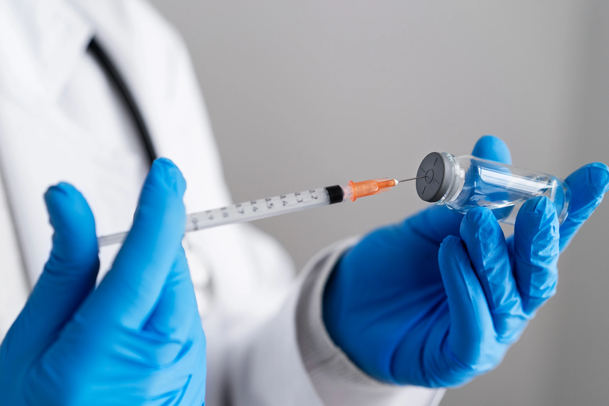side-view-doctor-holding-syringe-vial 1